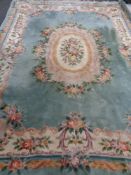 A green floral Chinese fringed carpet,