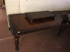 A reproduction Victorian mahogany style dining table with two leaves (castor needing attention)
