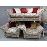 A three piece lounge suite in a floral fabric,