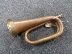 An antique brass and copper bugle