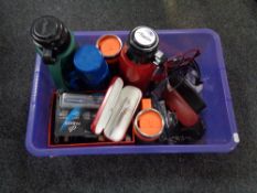 A crate of assorted flasks, Sheaffer & Parker pens, wallets,