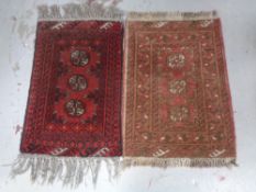 An Afghan rug, 80cm by 52cm, together with another similar,