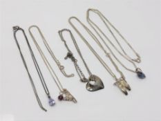 Five silver pendants on chains (5)