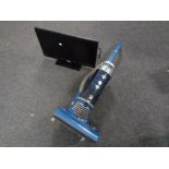 A Hoover upright vacuum together with a Altius 24" LED TV with lead and remote