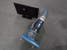 A Hoover upright vacuum together with a Altius 24" LED TV with lead and remote