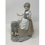 A large Nao figurine - lady standing by a broken pot, height 30 cm.
