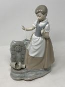 A large Nao figurine - lady standing by a broken pot, height 30 cm.