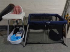 An Ikea high chair together with a Cugglo folding travel cot in carry bag,