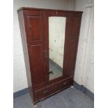 An antique stained pine mirror door wardrobe (a/f)