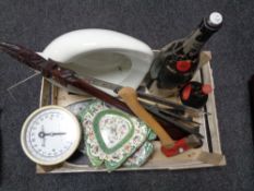 A basket of cast iron trivets, Booths Perfection bed pan, vintage Weigh Master scales,