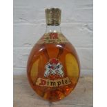 A bottle of Dimple 12 year old deluxe Scotch whisky,