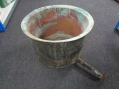 A large antique copper pot with draining arm and tap (internal width 58 cm )