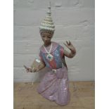 A large Lladro figure of a Thai dancer kneeling in matte finish, height 43.5 cm.