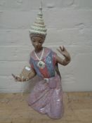 A large Lladro figure of a Thai dancer kneeling in matte finish, height 43.5 cm.