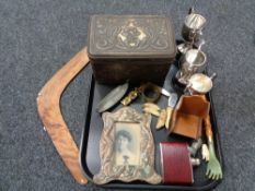 A tray of miscellany to include plated trophies, antique embossed tin, boomerang, hip flask,