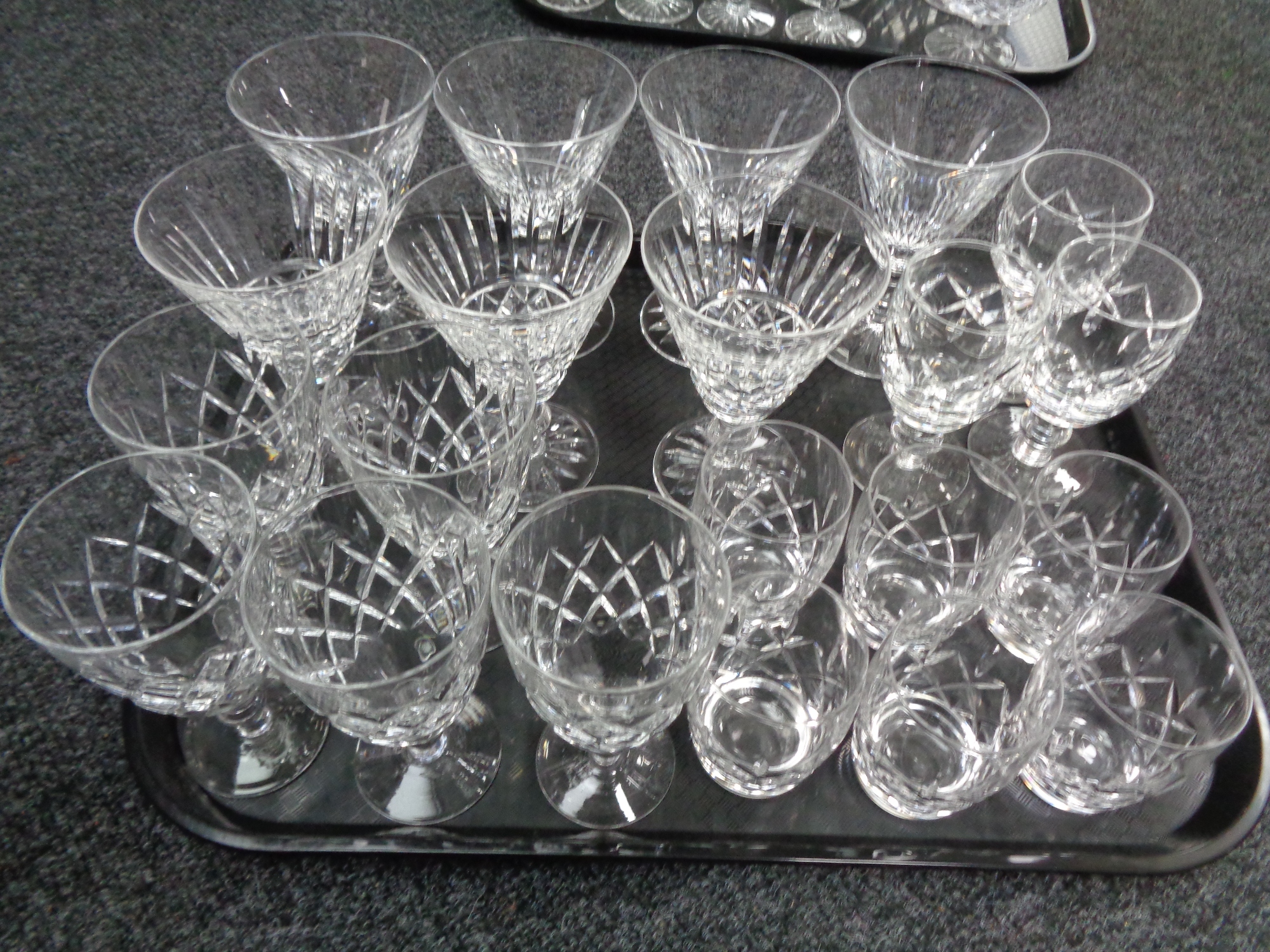 A tray of assorted lead crystal drinking glasses