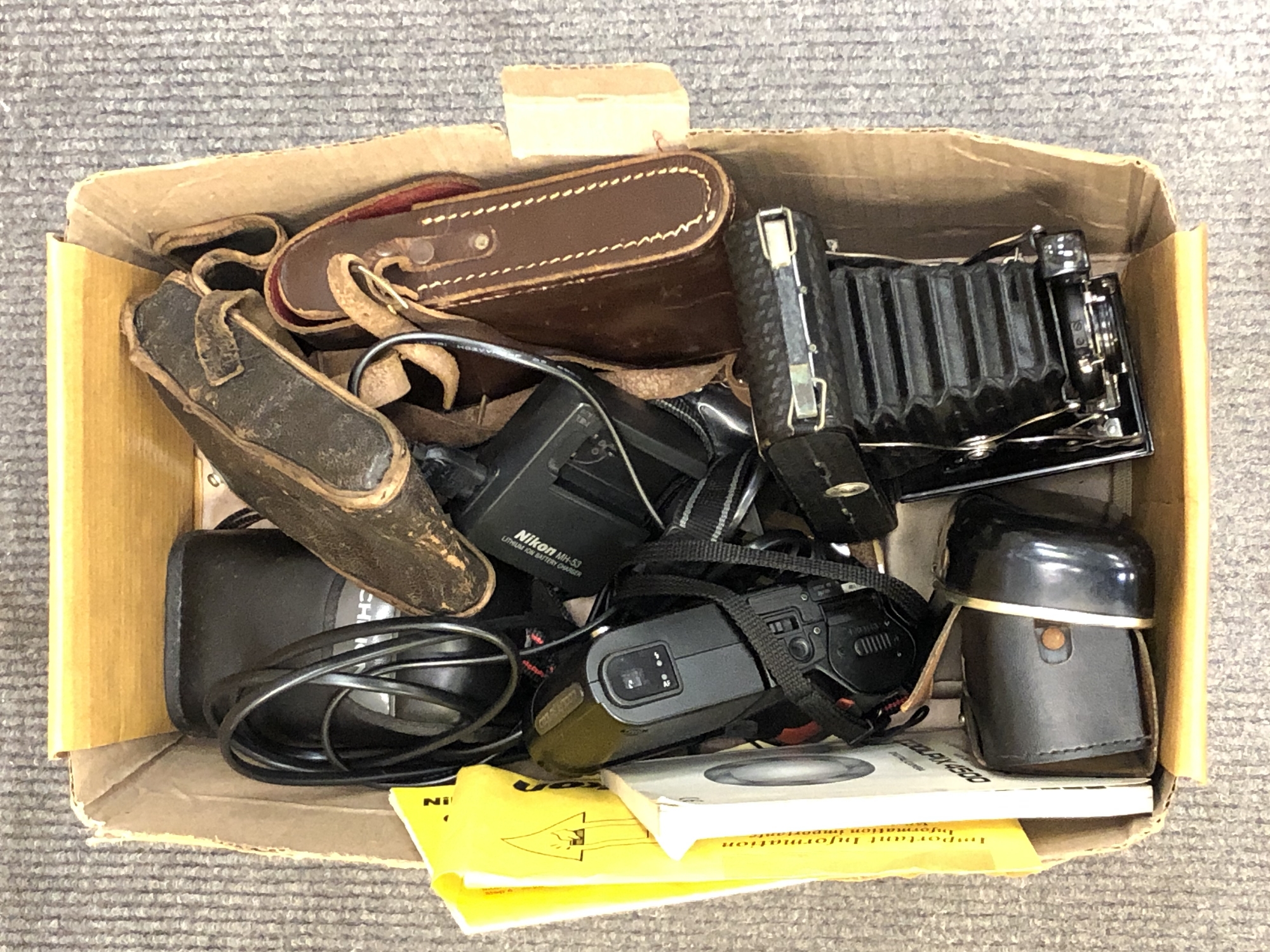 A box of cameras including Nikon, Kodak,