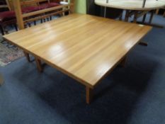 A large square oak coffee table