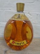 A vintage bottle of dimple old blended Scotch whisky,
