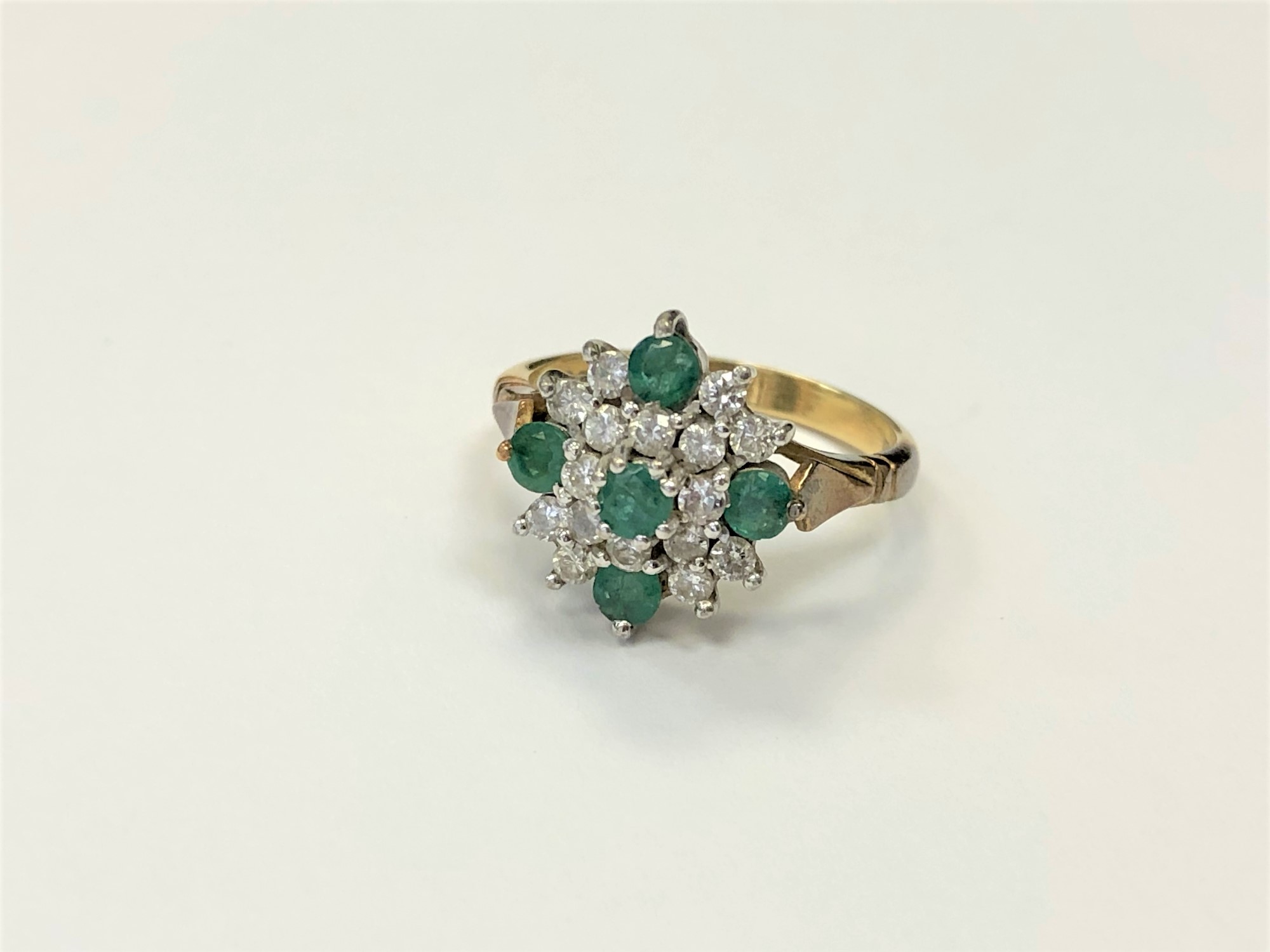 An 18ct gold emerald and diamond cluster, ring size N CONDITION REPORT: 5.