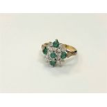 An 18ct gold emerald and diamond cluster, ring size N CONDITION REPORT: 5.