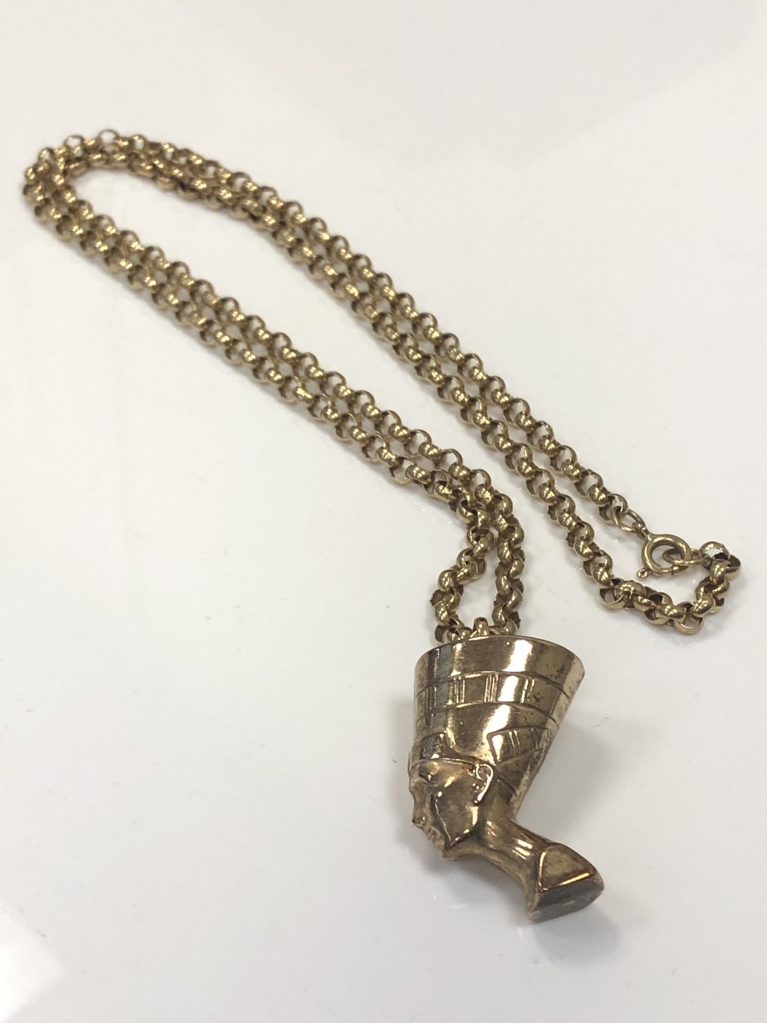 A 9ct gold pharaoh's head pendant on belcher-link chain, chain length 61cm.