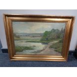 A 20th century continental school gilt framed oil on canvas, rowing boat at river side, signed T.E.