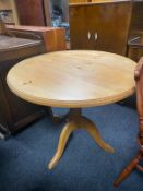 A circular pine kitchen table