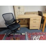 A contemporary oak three drawer computer desk and black mesh office chair