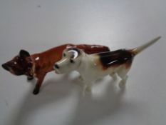 Three Beswick figures, fox and two hounds,