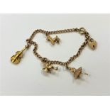 A 9ct gold bracelet with three gold charms, 10.