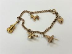 A 9ct gold bracelet with three gold charms, 10.