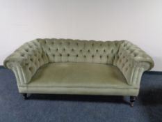An Edwardian Chesterfield sofa in green dralon, height 74 cm, width 193 cm, depth 90 cm.