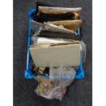 A plastic crate containing a quantity of lady's hand bags,