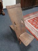 A carved hardwood fertility chair
