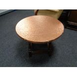 A circular copper topped coffee table