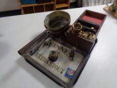 A tray of Guinness Extra Stout pub mirror, two antique cast iron handled pans,