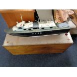 A remote control fire cruiser boat in plywood crate