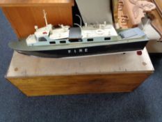 A remote control fire cruiser boat in plywood crate