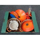 A box of Le Creuset cast iron pans,