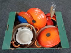 A box of Le Creuset cast iron pans,