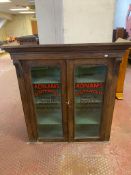 A Victorian mahogany double door bookcase bearing Adnams Southwold Brewery advertising,