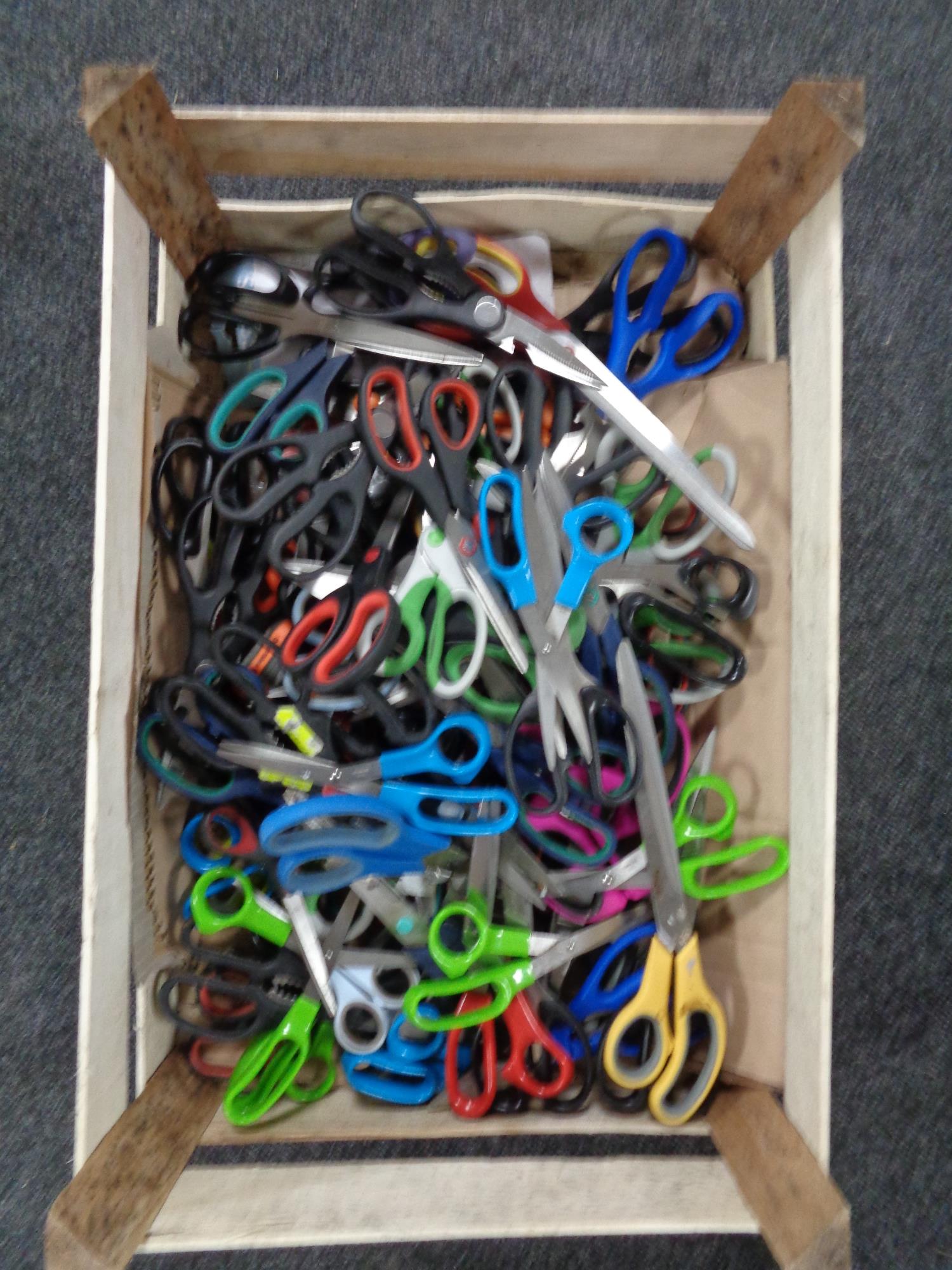 A box of a large quantity of scissors