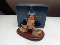 A Border Fine Arts figure of a fox on log, on wooden stand,