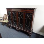 A late Victorian mahogany four door bookcase on claw and ball feet