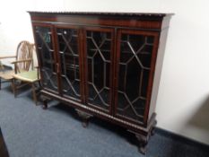 A late Victorian mahogany four door bookcase on claw and ball feet