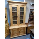 An early 20th century oak double door bookcase with cupboard beneath, height 207 cm, width 106 cm,