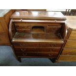 A mid 20th century beech cylinder writing bureau