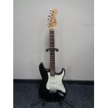 A Squier Stratocaster by Fender electric guitar on stand