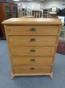 An antique pine five drawer chest with brass drop handles 115 cm x 89 cm x 50 cm